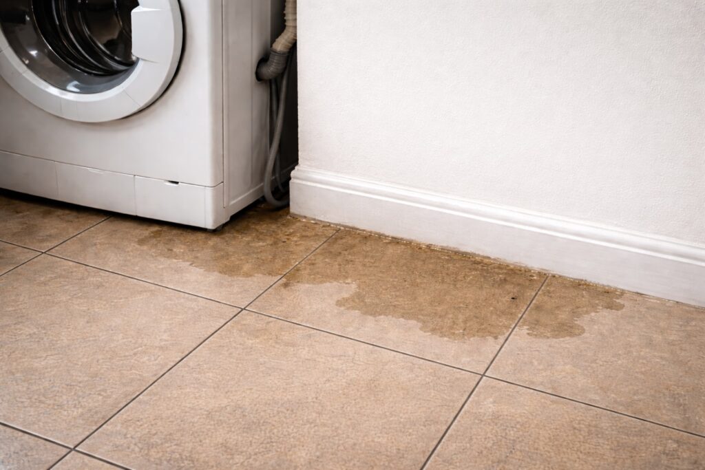 water leaking from washing machine onto utility room floor